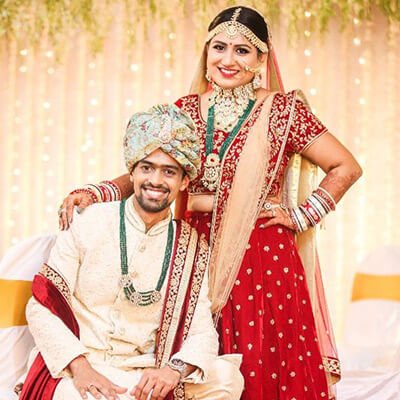 Beautiful Indian couple holding hands in traditional attire